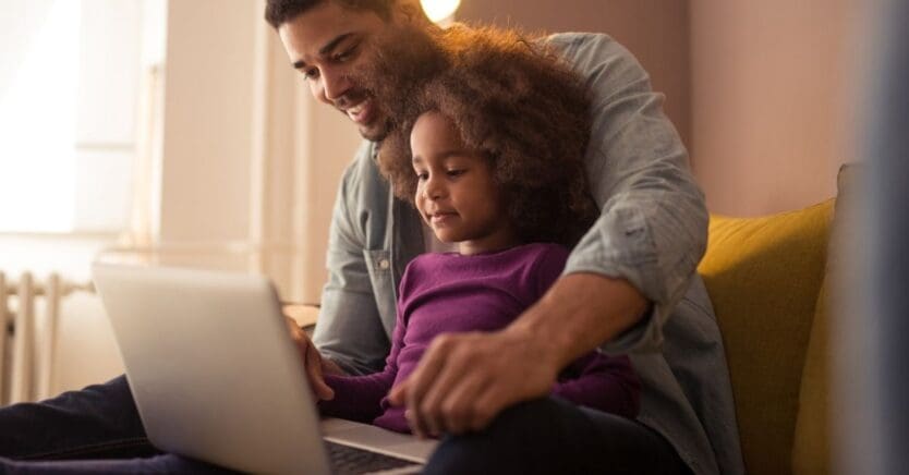 Father and Daughter Searching for a Private Preschool Online