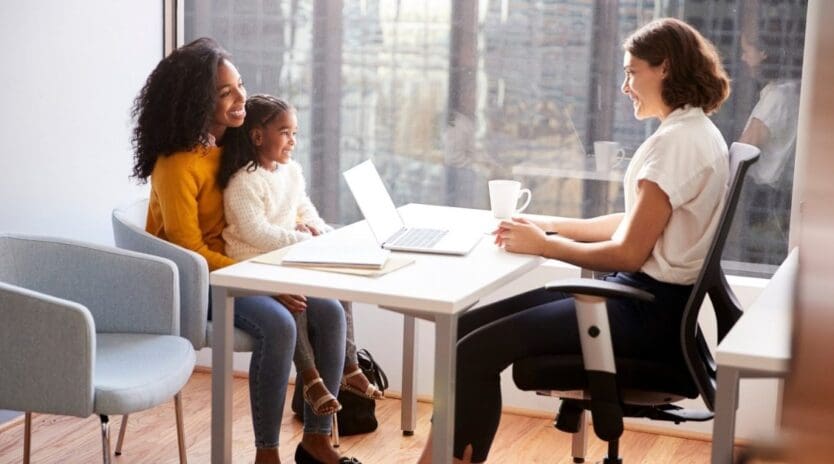 Mother And Daughter Having Consultation With Female Professional